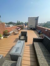 Rooftop Patio With Modern Furniture And A Grill