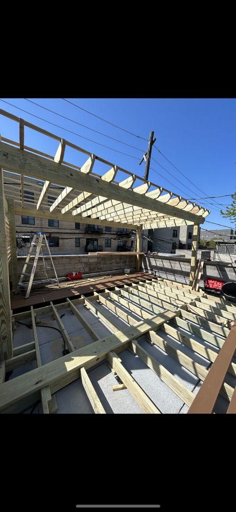 Construction Workers Building A Wooden Roof On A House